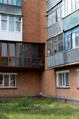 Wall of a old brick apartment house with a balconies	