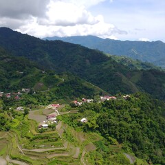Fototapeta premium Lush mountain landscape with terraced rice paddies