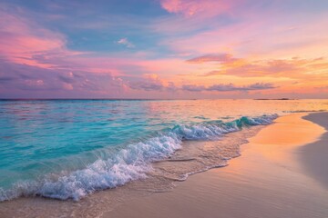 Fototapeta premium A vibrant sunset over a tropical beach. Soft waves lap at a pristine shore