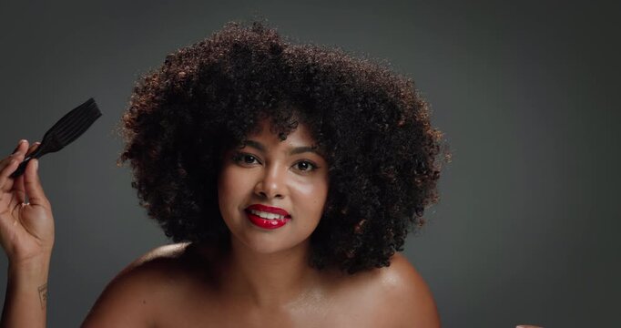 Face, hair care and African woman in studio with comb, beauty and glamour for aesthetic. Happy, portrait and black model in gray background with confidence, afro and natural volume with brush.