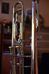 Trombone at close range, with the reflection of the room in the mirror in the background.