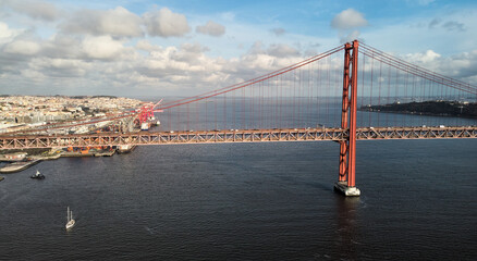 Aerial view of 25th April Bridge in Lisbon, Portugal. Famous landmark on river Tagus. High quality photo