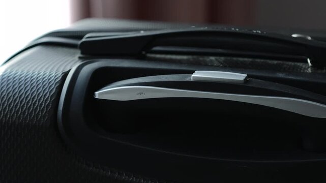 Handle on a travel suitcase.
Nylon and compact shockproof suitcase for travel.
Roomy travel suitcase for transporting personal belongings and clothes.