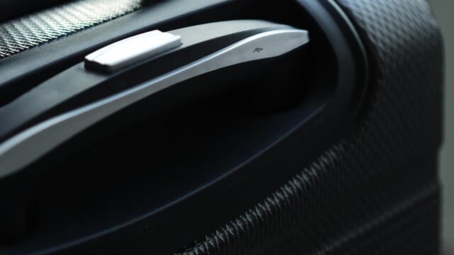 Suitcase for travel and tourism on long distances close-up.
Hand luggage at the airport.
Large and roomy gray travel bag