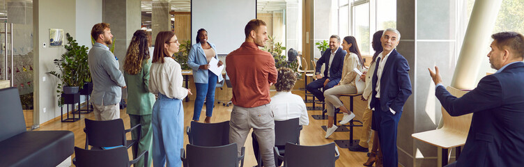 Team of people at master class in business training school. Group of diverse people, corporate company employees and coworkers, meet in office and learn to make public speeches. Banner, header