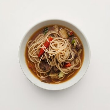 Overhead shot of Tibetan thenthuk noodle soup filled with noodles, meat, and various sliced vegetables.