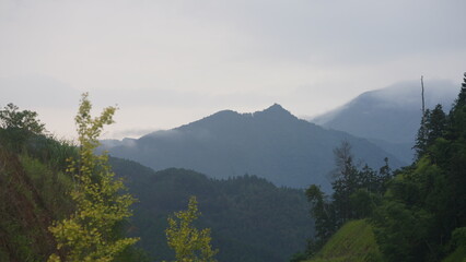 The beautiful mountains view with the covered fog on them