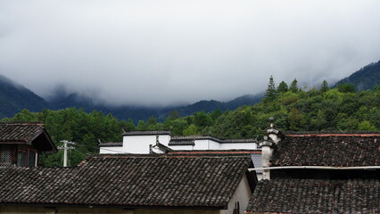 The beautiful mountains view with the covered fog on them