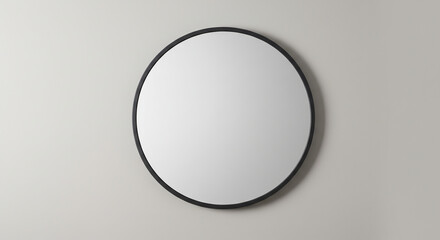 A simple, round mirror with a black frame is mounted on a neutral, light-colored wall.