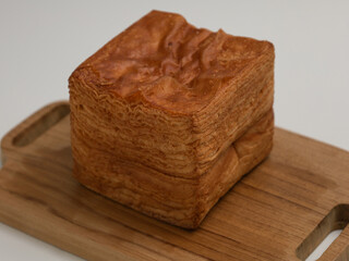 Tissue bread or layer toast on wooden cutting board