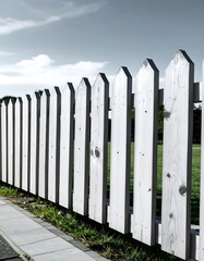 White Wooden Fence with Green Grass and Blue Sky