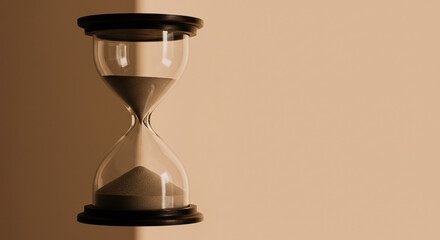 An hourglass, partially filled with sand, sits against a muted beige backdrop, casting a subtle shadow.