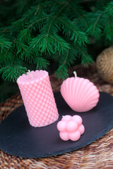 Set of handmade pink beeswax candles in bubble cube, shell, and textured pillar designs. Stylish eco-friendly home decor and gift idea.