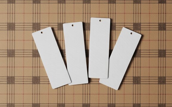 Minimalistic mockup of four paper bookmarks with round holes on top, lying on a brown plaid wool blanket, flat lay.
