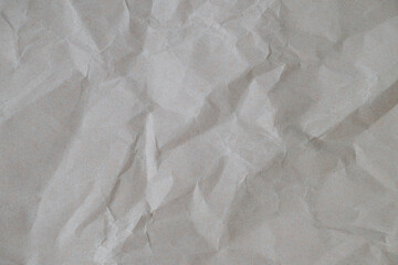 Wrinkled gray kraft paper texture with deep creases