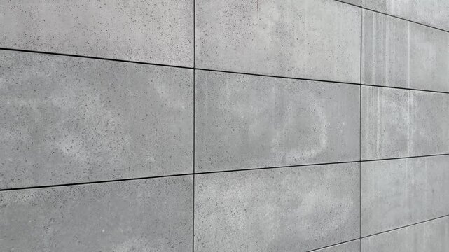 se-up view of facade tiles crafted from architectural concrete, highlighting their smooth surface, modern texture, and geometric arrangement.