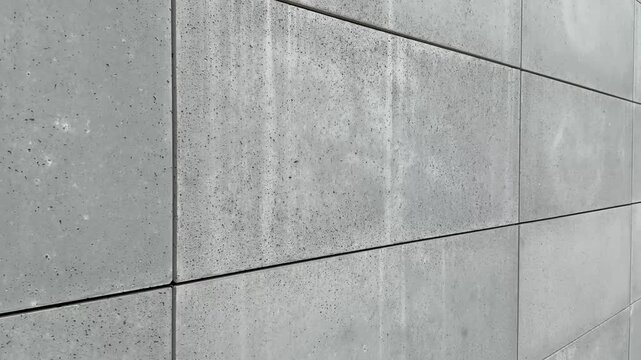 se-up view of facade tiles crafted from architectural concrete, highlighting their smooth surface, modern texture, and geometric arrangement.