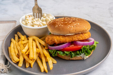 chicken fillet sandwich  with french fries and   macaroni salad