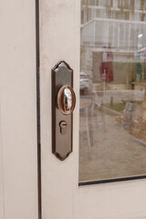 Close up of wooden door with classic golden handles and ornaments,gold door handle and lock,Beautiful entrance to an expensive home or Luxury hotel,Copy space.