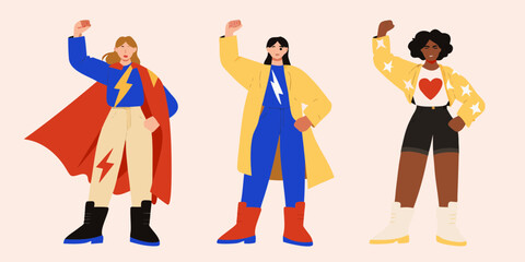Three diverse women standing strong with fists raised in a powerful superhero pose © Sanjoy