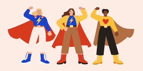 Three diverse women dressed as superheroes strike a powerful pose demonstrating strength and unity © Sanjoy