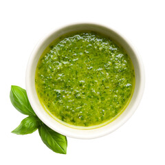 Bright green pesto sauce sits in a white bowl beside fresh basil leaves Perfect for pasta or as a flavorful spread