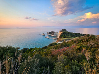 Pastel sunset sky over Cape Drastis with coastal vegetation, Corfu.