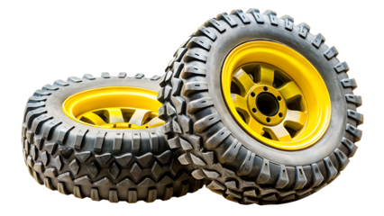Two large off road monster truck tires with yellow rims isolated on a transparent background 2