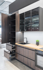 modern  kitchen. built-in kitchen furniture, upper and lower cabinets, built-in appliances. Black faucet and sink. Wooden kitchen. the kitchen is brown shades.