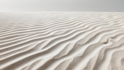 Obraz premium Sand dunes with ripples on a desert surface under a gray sky.