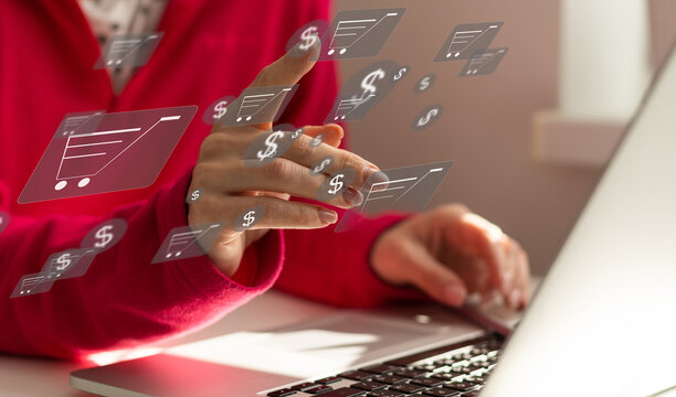 Online shopping and e-commerce concept. Young woman using laptop computer with shopping cart icon, order in online store, shopping on internet, concept on virtual screen with hands typing on keyboard