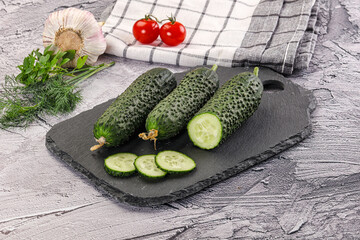 Raw green cucumbers with slices