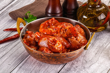 Raw marinated buffalo chicken wings