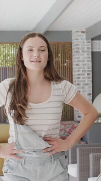 Vertical video: Entering patio, girl is lip-syncing to camera while brushing hair and gesturing