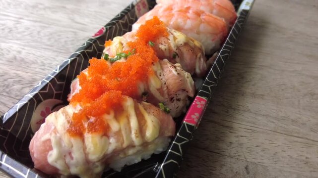 Four pieces of Japanese sushi served in a plastic box for those who want to buy it to take home for dinner.