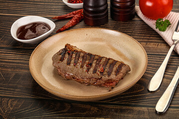 Grilled beef striploin steak with sauce