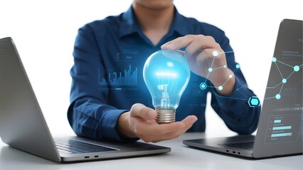 Person holding a glowing light bulb with digital data projections between two laptops