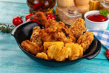 Golden crispy fried chicken mix - wings, drumsticks, nuggets and strips