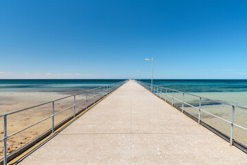 Ardrossan Jetty on a bright day against blue sky, Yorke Peninsula, South Australia