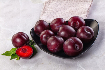 Raw ripe purple plum heap