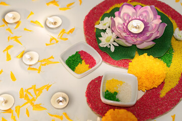 Diwali candle arrangement with colorful flowers and decorative elements