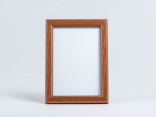 Wooden picture frame with simple, elegant design stands against plain background, highlighting its natural wood grain and smooth finish. frame is empty, ready for photo or artwork