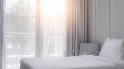 A serene hotel bedroom bathed in morning sunlight, featuring a neatly made bed and sheer curtains.