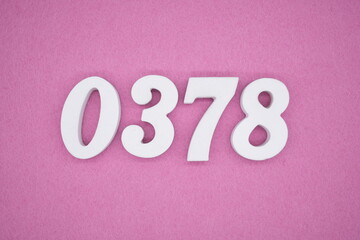 The numbers are made of white painted wood, placed on a pink paper background.