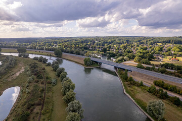 Interstate road a348 passing river IJssel valley with floodlands on either side. Aerial inland shipping waterway infrastructure concept.