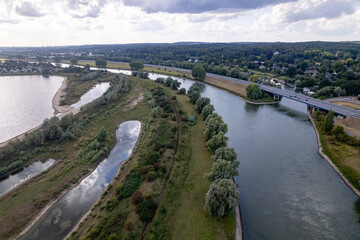 River IJssel valley in Dutch landscape with floodlands on either side. Aerial inland shipping waterway infrastructure concept