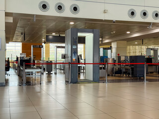 Airport security checkpoint with scanning machines and gates. Safety, regulation and travel control in modern transportation systems.