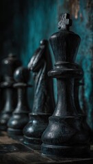 A close-up view of a dark, aged black chess king piece, standing prominently against a teal-toned background.