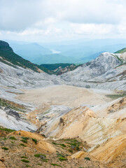 Fototapeta premium Scenic Volcanic Valley Landscape with Mountains and Clouds