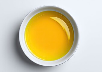 Top-down view of a bowl filled with yellow liquid